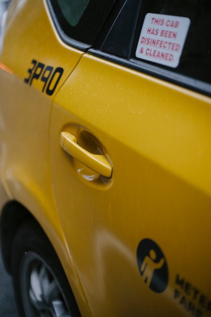 Modern clean shiny yellow automobile with stickers and inscriptions parked on asphalt road